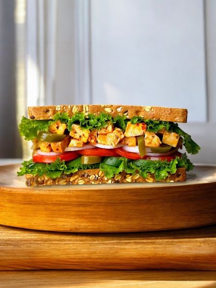A closer look at our Thai Veggie Crunch Tofu Sandwich, featuring spicy tofu and fresh vegetables. It's a delicious and healthy option that's part of our special ₹99 deal, so you can enjoy great taste without breaking the bank.