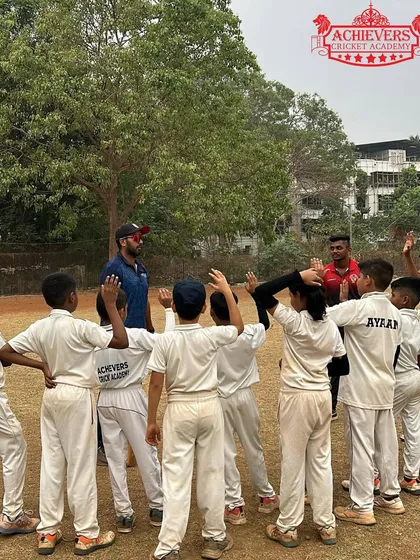 A team huddle with coaches during the summer camp, fostering teamwork and communication.