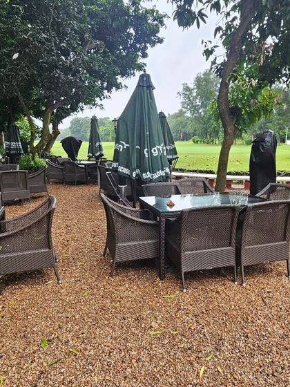 Even on a rainy day, our furniture stands ready. This image from a prestigious Kolkata club shows our all-weather sets and umbrellas, proving that quality trusts quality.