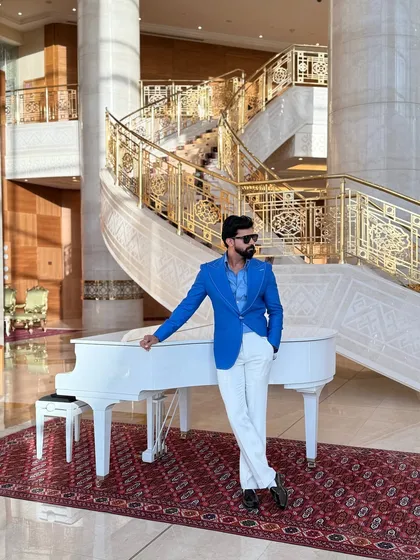 Make a vibrant statement with our electric blue linen blazer. Featuring wide lapels and handcrafted details, this jacket is set against a luxurious backdrop, showcasing a lifestyle of elegance and confidence.