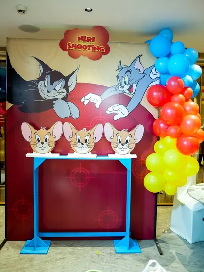 A custom "Nerf Shooting" game stall with a Tom & Jerry theme, where kids can aim for Jerry-shaped targets.
