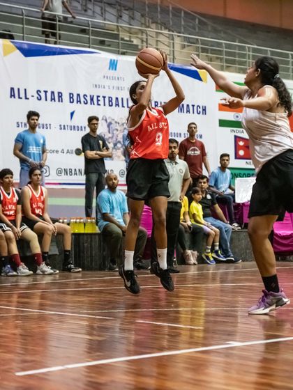 A player executes a perfect jump shot during a competitive match. Our academy emphasizes fundamental skills that hold up under the pressure of a real game.