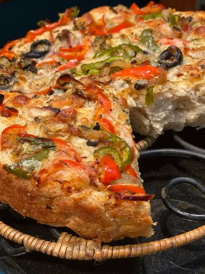 A thick-crust focaccia pizza, loaded with fresh vegetables and cheese. This is a hearty and satisfying option that can be served as a main or cut into smaller slices for an appetizer.