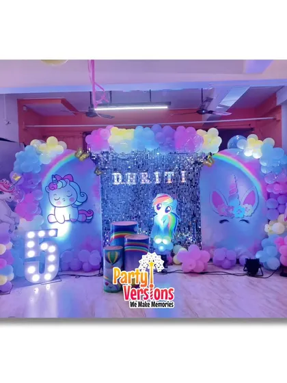 A glimpse into the magical worlds I create. This is a full Unicorn-themed birthday setup, featuring a custom backdrop with a shimmering curtain, a rainbow balloon arch, and light-up marquee numbers for that extra sparkle.