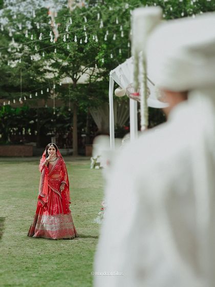 The first look. The groom sees his bride for the first time, and her radiant smile says it all. A beautiful moment from an outdoor wedding.