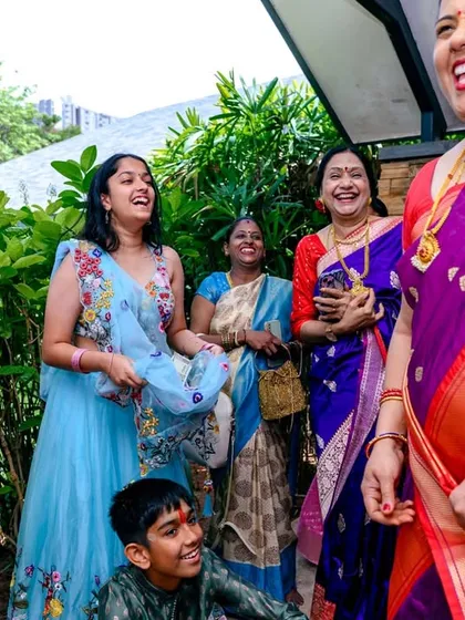 The best moments are often unposed. This photo from a thread ceremony captures the pure, spontaneous laughter shared between family members during a sacred and joyous occasion.