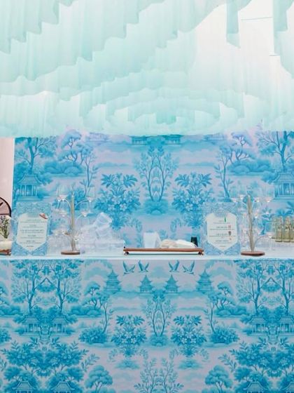 The food and beverage station, fully integrated into the Dior theme with a custom-printed facade that matches the event's signature blue and white pattern.