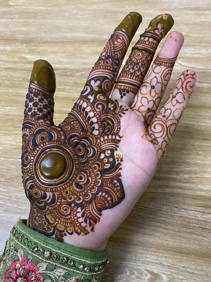 The same design, showing some parts with fresh paste and others where it has been removed, demonstrating the "cutwork" or negative space technique.