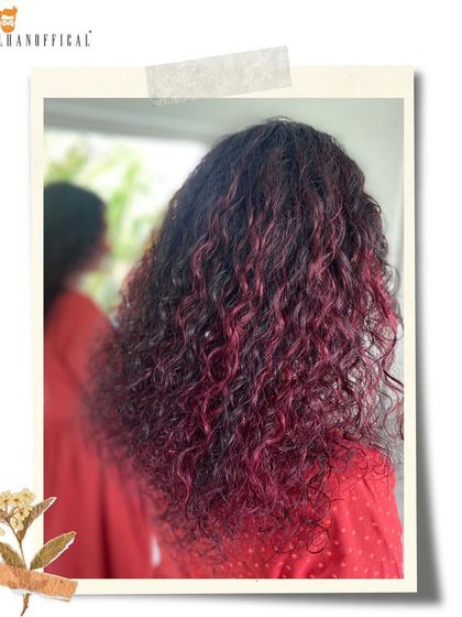 The swirls of magenta and deep red in these curls are simply stunning. This is a perfect example of how to wear a bold color with elegance and confidence.
