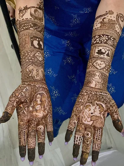 An incredibly detailed maternity mehndi design. It tells a complete story with portraits of the parents, baby footprints, a feeding bottle, and other symbols of the journey to parenthood.