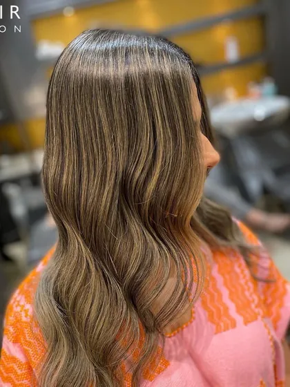 Another view of our Monday makeover, showcasing the seamless blend of highlights and the healthy shine of the hair.