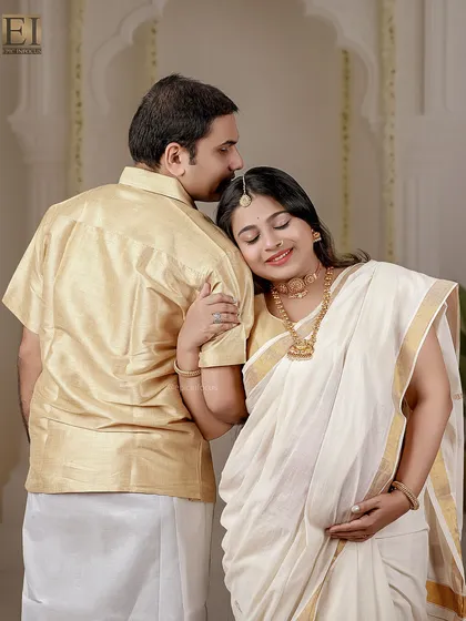 A gentle kiss on the forehead is a timeless expression of love and care. This portrait from a traditional Kerala-themed shoot captures that tenderness.