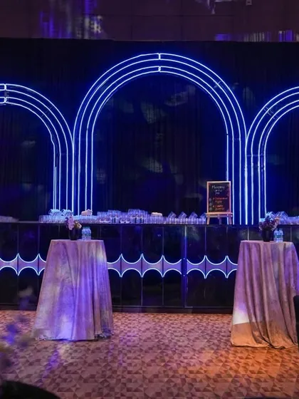 Another view of the modern cocktail bar, with its clean lines and striking neon arch design, ready for an evening of celebration.