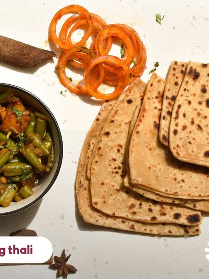 A simple, wholesome, and delicious vegetarian thali. Here you see a seasonal veg sabzi with parathas and a side of spiced onions. It's the kind of everyday food that you'll never get tired of.