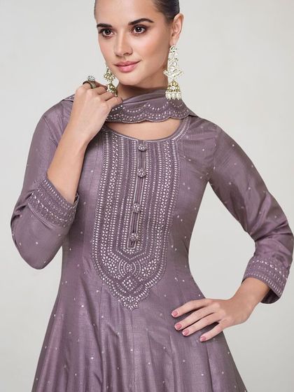 This dusty purple premium silk gown is modern and chic. The unique neckline and subtle sequin work make it a sophisticated choice for any formal event.