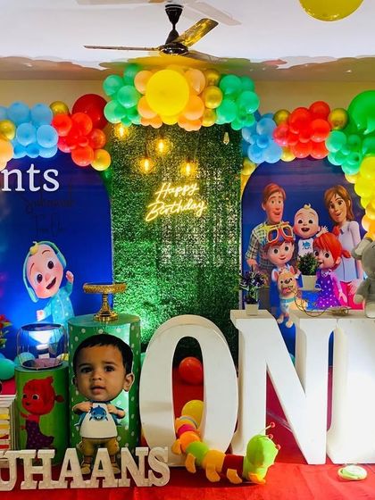 A fun Cocomelon setup that includes personalized cutouts of the birthday boy.