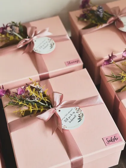 When you find your tribe, keep them close! These pink boxes are tied with a beautiful floral detail and a "Will you be my bridesmaid?" tag.