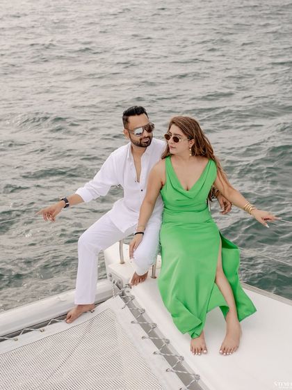 A candid, joyful moment between the couple on the yacht.
