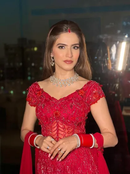 A powerful, modern bridal reception look. The clean makeup and sleek hair create a look that is both sophisticated and striking.