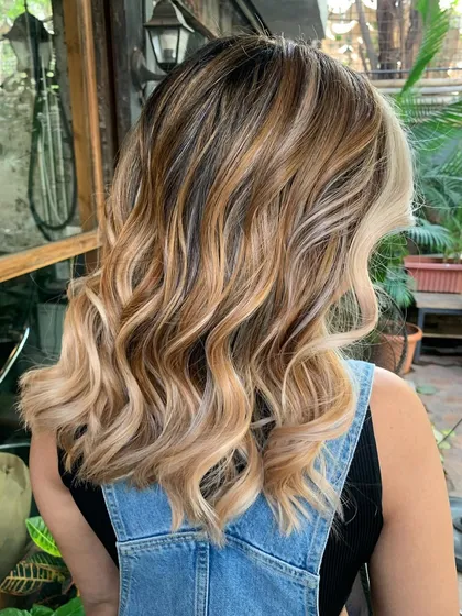 A side profile of the 'Cookies and Cream' look, showing the beautiful face-framing highlights.