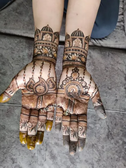 A simple yet elegant Indian design with palace architecture and peacock motifs. This wrist-length design is perfect for someone who wants a touch of tradition without heavy coverage.