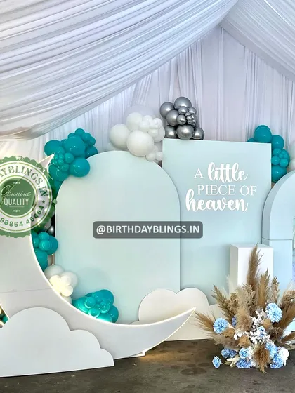 A close-up of the moon and cloud cutouts, showing the dreamy details of the baby shower theme.