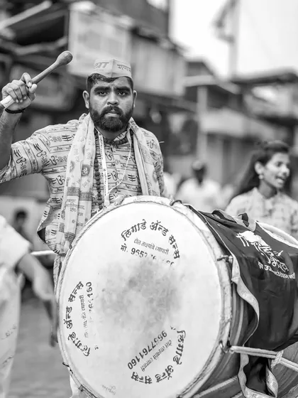 The black and white version of the intense dhol player, adding to the drama.