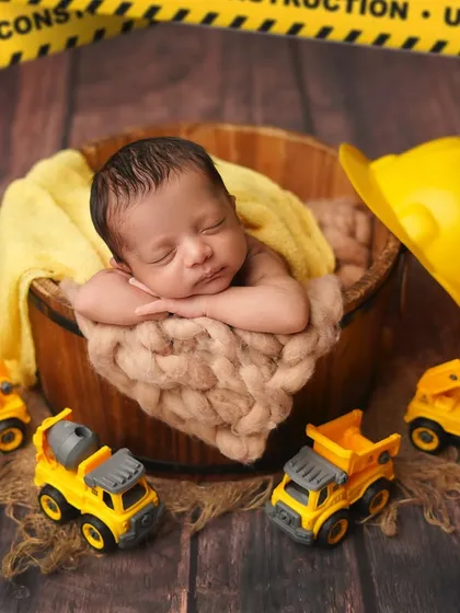 A wider view of the construction site, with 'Under Construction' tape in the background. This is a great theme for a baby boy's photoshoot.