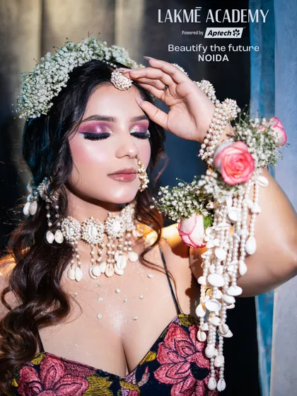 A detailed close-up of the Haldi makeup. The pink and purple eyeshadow, combined with shell and floral jewelry, creates a unique and memorable pre-wedding look.