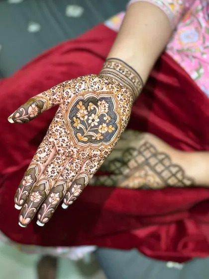 The palm side of the engagement mehendi, featuring a stunning floral motif at the center.