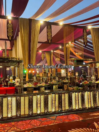 Another angle of the grand buffet, this image highlights the intricate geometric patterns on the illuminated counter front. The setup is designed to be a visual centerpiece of the event.