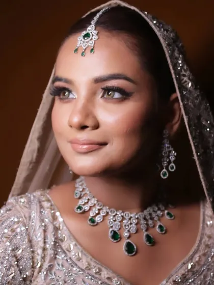 A close portrait of the dreamy bridal look, highlighting the flawless base and soft, shimmering eye makeup.