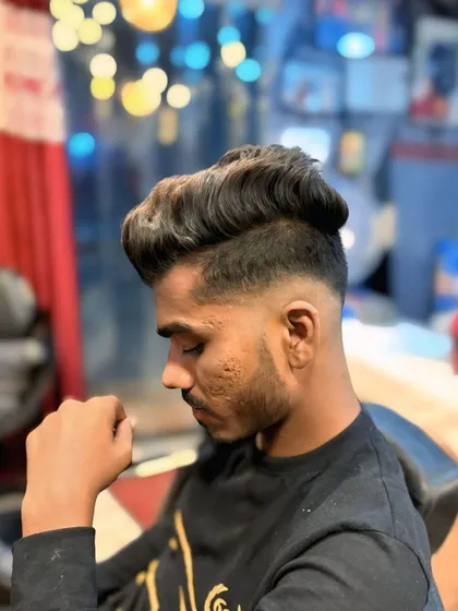 This haircut features a high fade with plenty of volume and texture on top. The sharp contrast creates a bold and modern style.