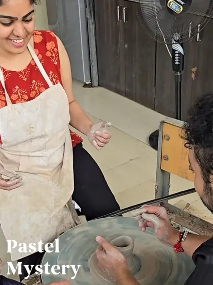 A fun moment between a couple at the pottery wheel. The experience is just as much about the process and the connection as it is about the finished piece.
