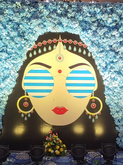 A full view of the quirky bride photo booth against a wall of blue flowers. This custom installation provided a fun and memorable backdrop for guests at a blue pottery themed Haldi.