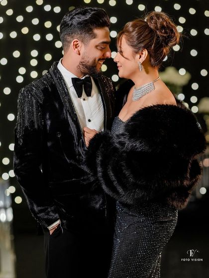 Sahil and Aerie looking glamorous for their cocktail night. The bride's fur wrap and the bokeh background create a feeling of old Hollywood elegance.