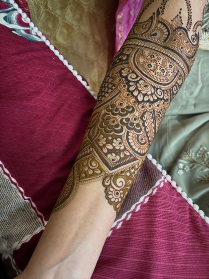 The full arm view showcases the different sections of the design, from the wristband to the elbow cuff. Each part has its own unique pattern, yet they all work together harmoniously.