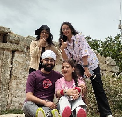 Friends and family making memories on the ancient rocks of Lepakshi. My trips are all about creating stories that last forever.