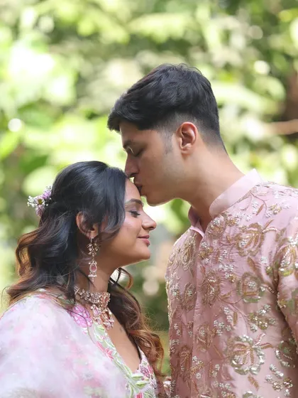 An intimate and beautiful shot. The bride's soft makeup, with its rosy tones and gentle shimmer, looks flawless even in natural outdoor lighting.