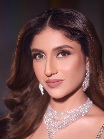 A detailed close-up of the sangeet makeup. The matte nude lip perfectly balances the dramatic eye makeup, creating a look that is both powerful and chic.