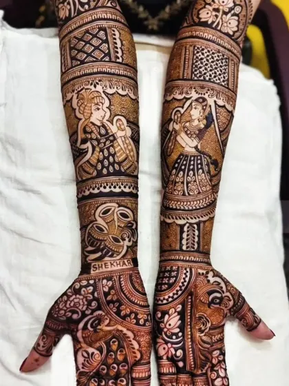 This design tells a story with figures of a woman with a baby and another on a swing. It's personalized with the name 'Shekhar' and is a great example of narrative mehendi.