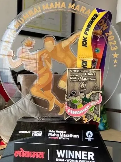 A close-up of the impressive trophy and finisher's medal from the Maha Mumbai Maha Marathon 2023. Each award is a symbol of the dedication required to compete at a high level.