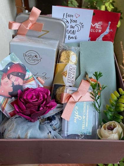 A romantic gift box perfect for her. This hamper is filled with pampering and sweet items, including Body Cupid perfume, a face mask, Ferrero Rocher chocolates, a stylish scarf, and a personal note.