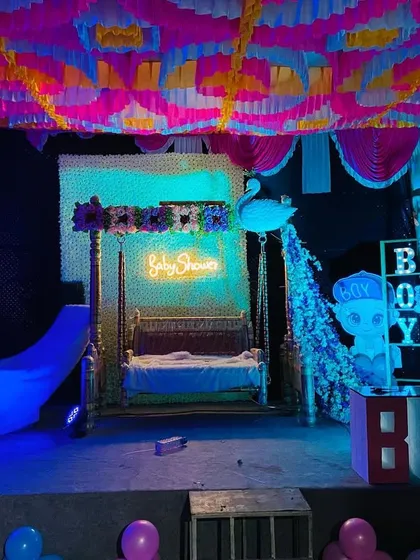 The baby shower stage illuminated with blue lights, creating a magical nighttime ambiance.