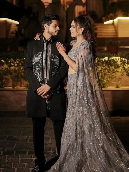 A romantic portrait of the couple. Her glass skin and glam eyes are the perfect complement to the sophisticated, sparkling grey lehenga.