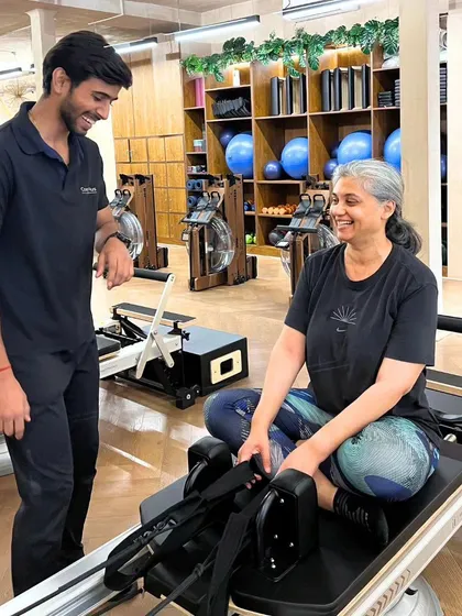 Every session is a partnership. Here, I'm working with a client to ensure her form is perfect and she feels supported. It’s this personalized guidance that makes all the difference, especially for those new to Pilates or rowing.