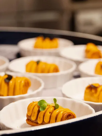 Artfully piped and torched canapés being prepared for a high-profile event, demonstrating our attention to detail in every bite.