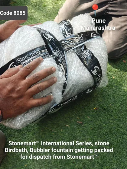 A natural rock bubbler fountain being carefully wrapped in bubble wrap and secured with our branded tape before being crated.