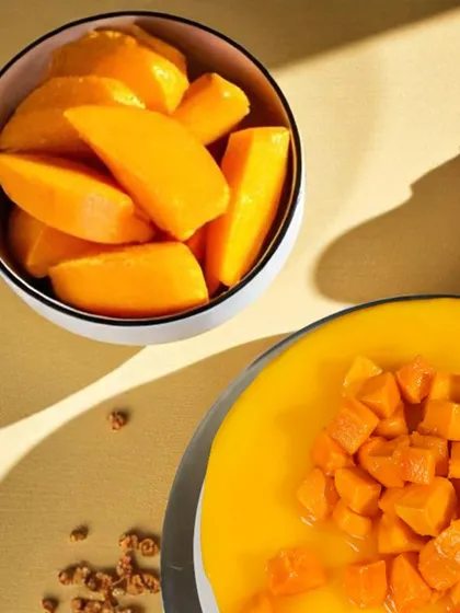 A close-up on the fresh, juicy mango slices we use to top our cakes. Quality ingredients are our obsession.