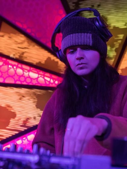 DJ Offering Rain, a frequent collaborator, spinning at the Bolliday Edition. I build relationships with a core group of talented DJs to ensure a consistently high-quality musical experience.